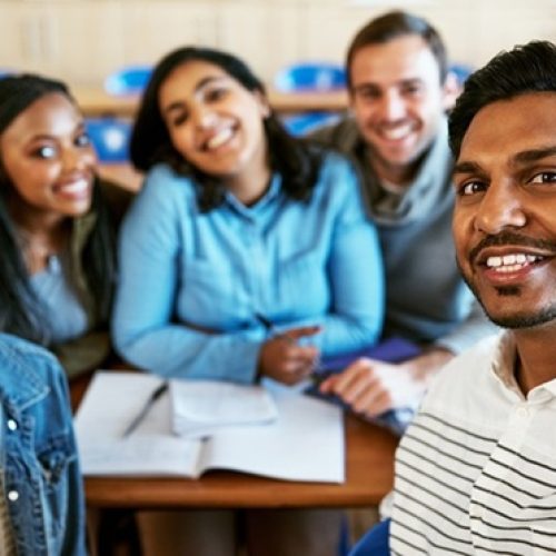 College is awesome. Cropped portrait of a group of young university students sitting in class